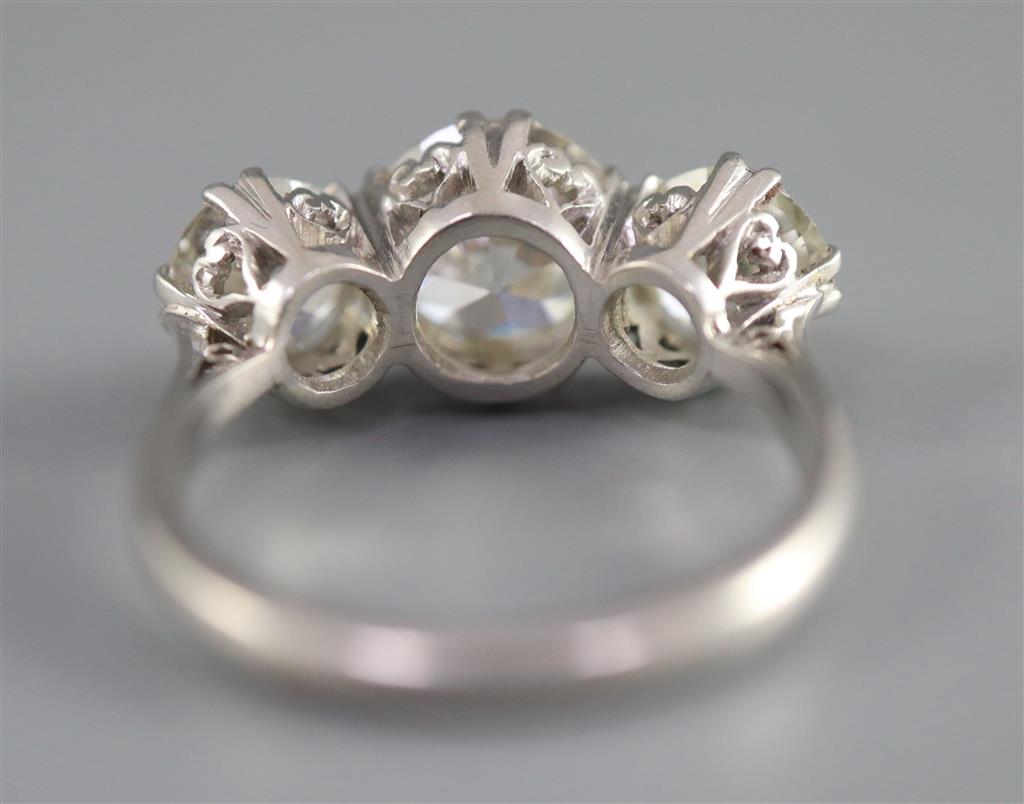 An impressive platinum and three stone diamond ring,